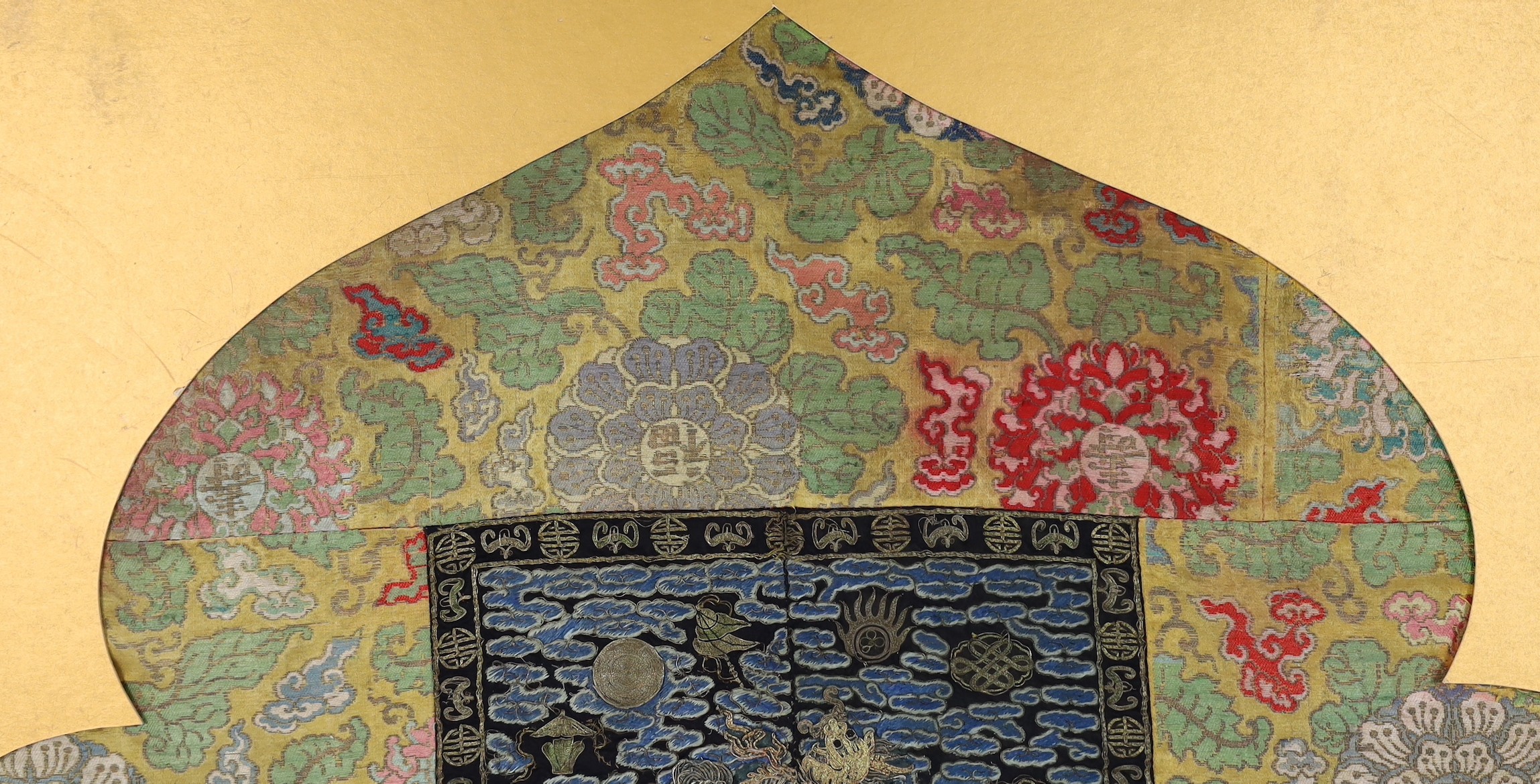 A 19th century Chinese embroidered silk military rank badge with 17th century silk brocade borders, total size 69.5cm x 83.5cm